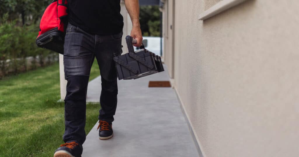 After learning how to replace a well pump, homeowner is heading outside with his tools.