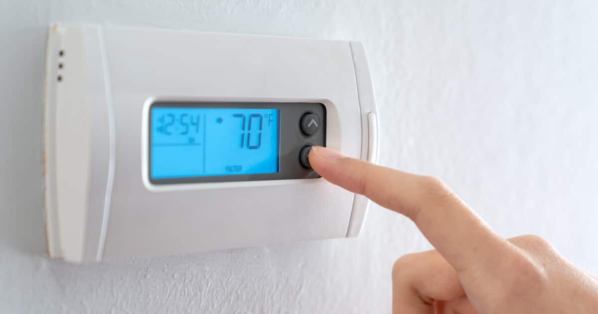A person is turning on their AC in the spring after learning when to turn on AC.